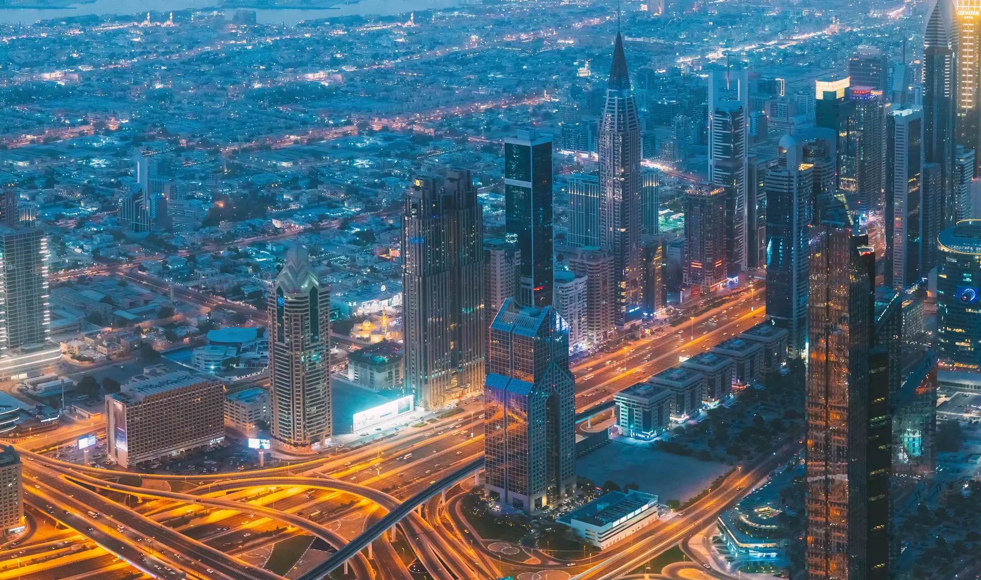 Best nights to go out in Dubai — the Sheikh Zayed Road towers and the Trade Centre interchange lit at blue hour, the strip whose clubs post the same hours seven nights a week