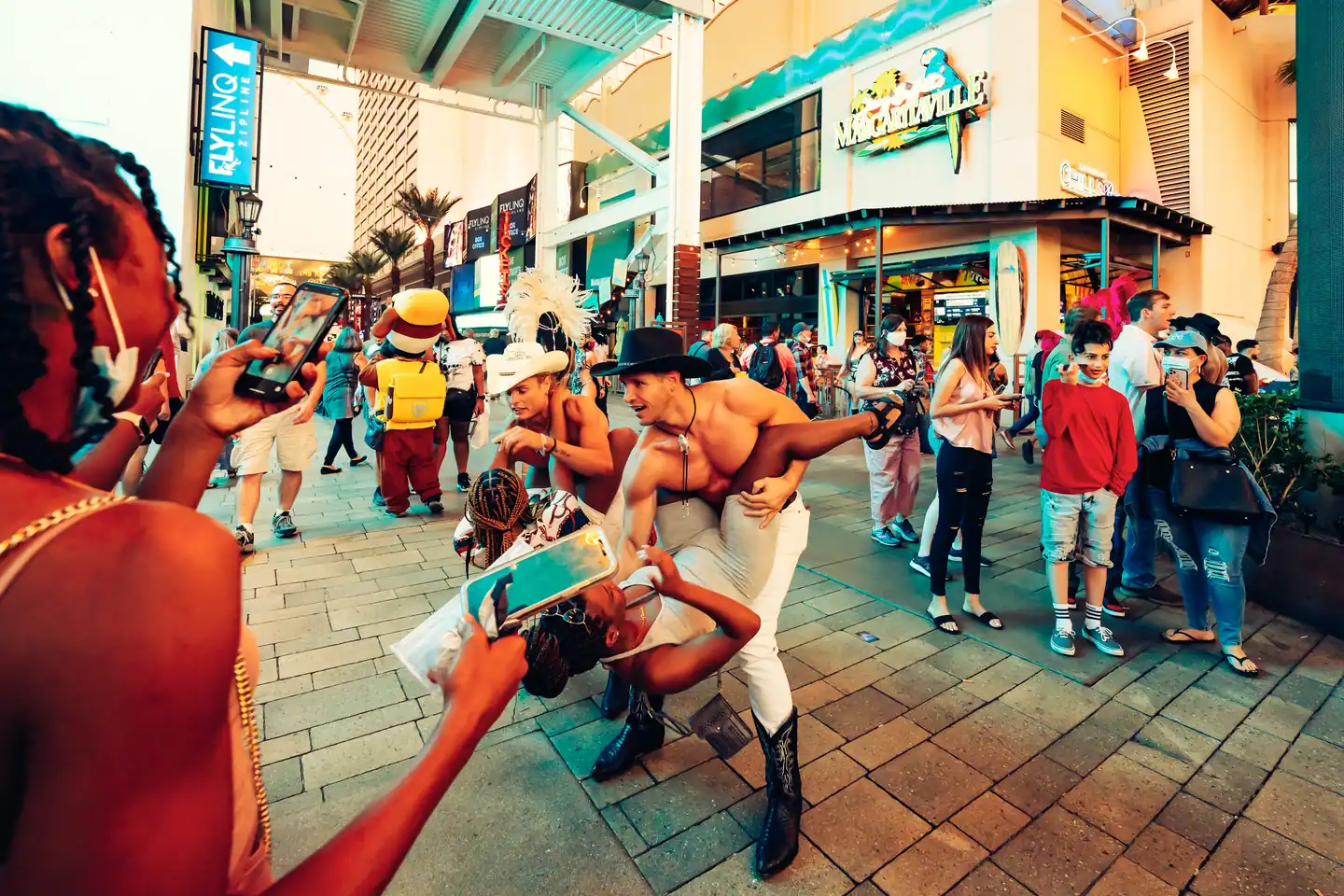 Best nights to go out in Las Vegas — street performers and a crowd on the LINQ Promenade off the Strip at dusk