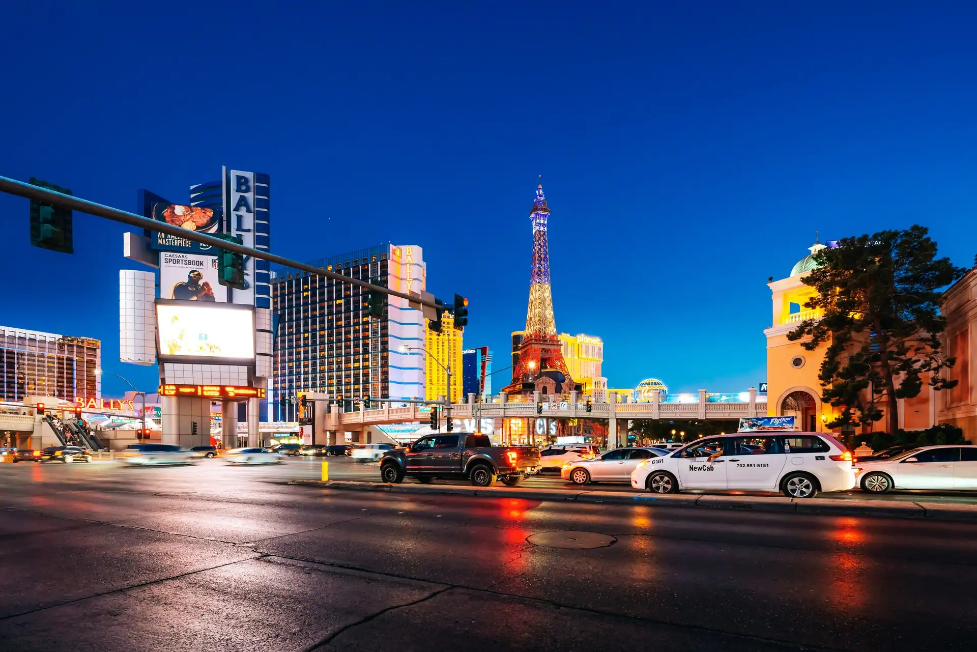 Las Vegas nightlife guide — the Strip at dusk, Paris tower and Bally's lit, the bottle-service belt before the doors open