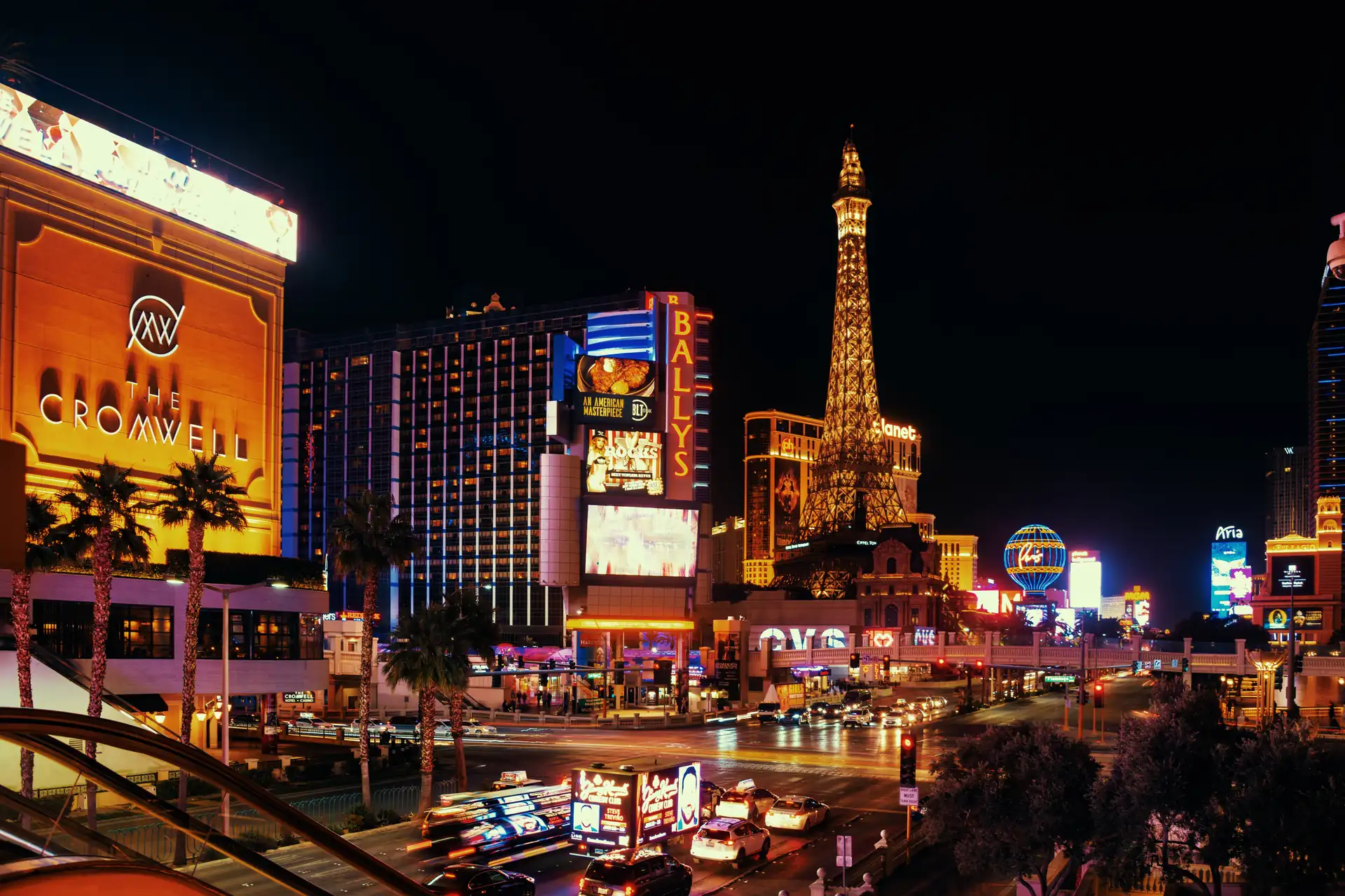 Clubs in Las Vegas — the Strip at night from the Cromwell corner, Paris and Bally's lit up across Las Vegas Boulevard