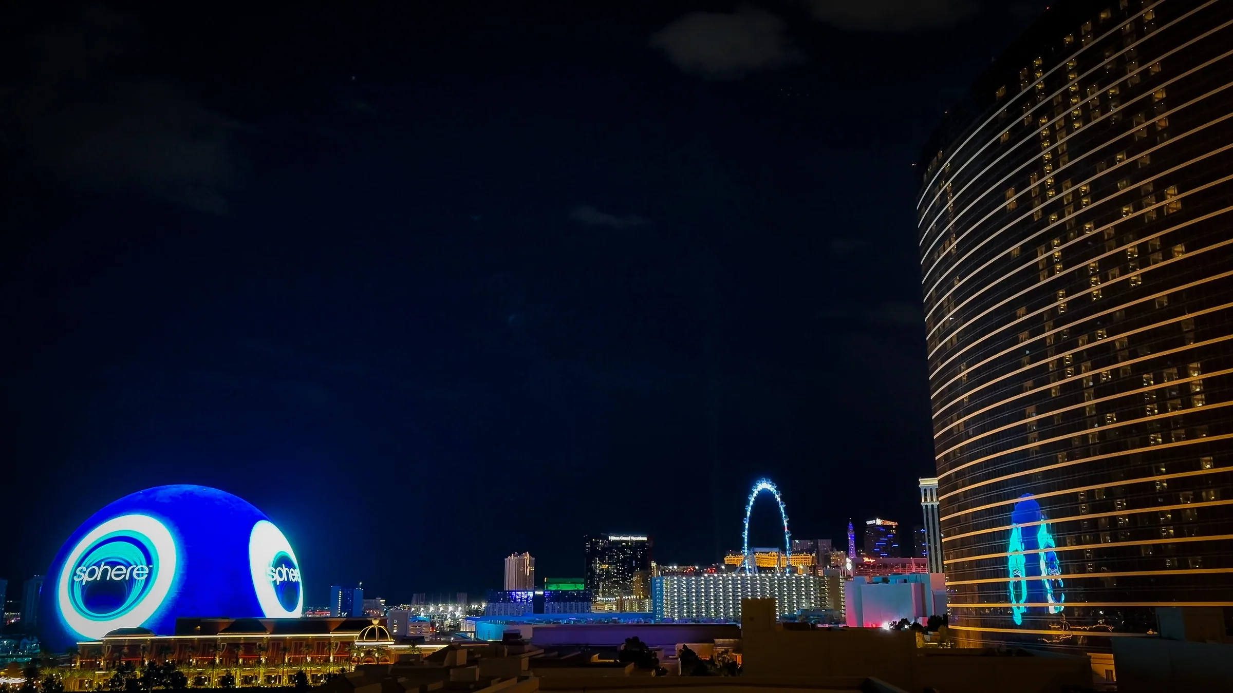 Las Vegas nightlife — the Strip skyline at night with the Sphere lit up and the High Roller wheel behind it